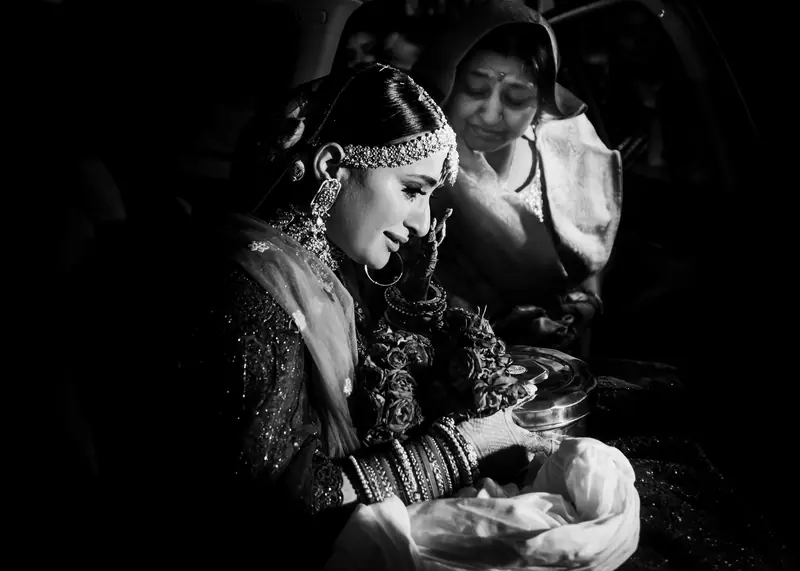 A quiet black and white frame of a bride and her father