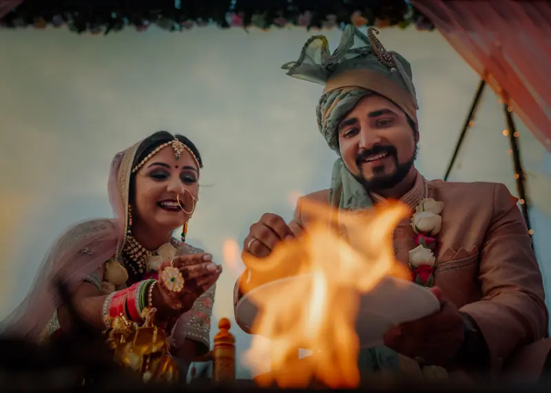 Bride and groom lighting the sacred fire during the pheras