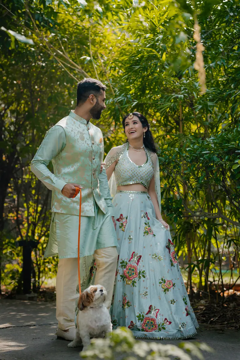 A couple with their dog at a mehendi function