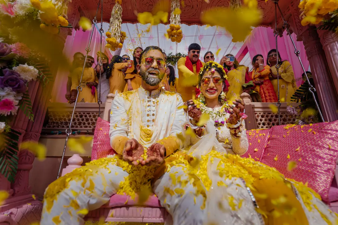 Turmeric being pressed onto the couple during the haldi
